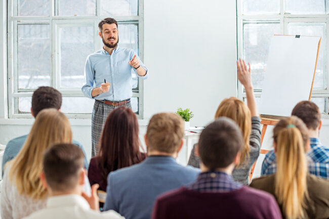 Speaker,At,Business,Meeting,In,The,Conference,Hall.,Sharing