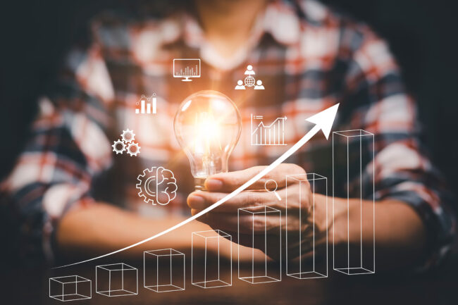 Businessman,Holding,Light,Bulbs,,New,Ideas,With,Of,Stock,Market